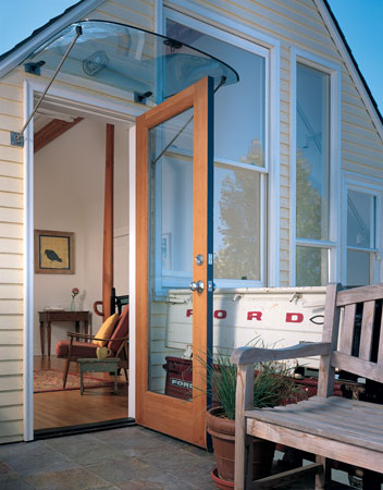 
Old truck tailgates and windshields make surprisingly elegant awnings and railings, in this case for the back balcony.
